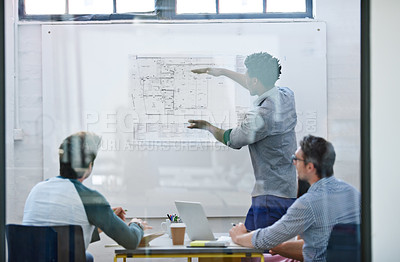 Buy stock photo Cropped shot of a group of architects discussing plans