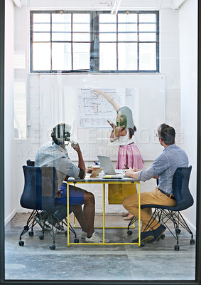 Buy stock photo Cropped shot of a group of architects discussing plans