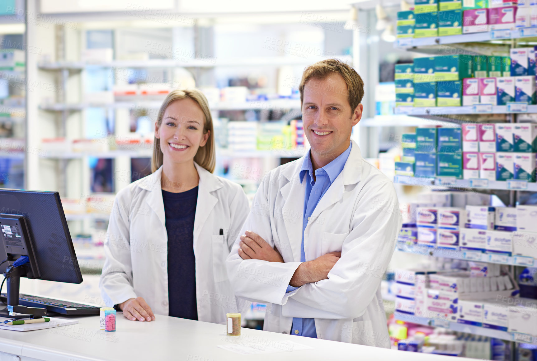 Buy stock photo Pharmacy, man and woman in portrait with smile, confidence and prescription drugs in clinic. Teamwork, advice and pharmacist with arms crossed, medicine and pills for medical service at counter