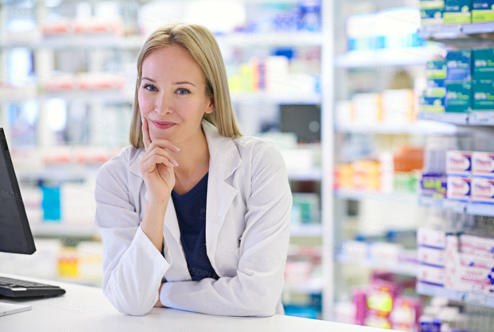 Buy stock photo Portrait of an attractive pharmacist standing at the prescription counter