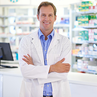 Buy stock photo Portrait of a handsome pharmacist standing at the prescription counter