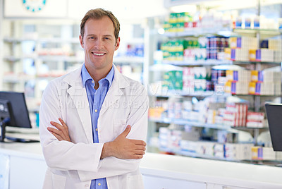 Buy stock photo Portrait of a handsome pharmacist standing at the prescription counter