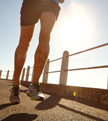 Buy stock photo Cropped shot of a man jogging on the promenade