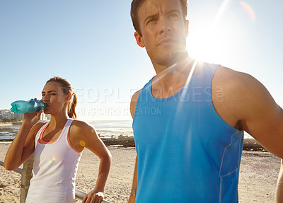 Buy stock photo Shot of a couple taking a break after a jog