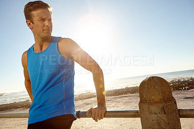 Buy stock photo Shot of a man taking a break after a long jog