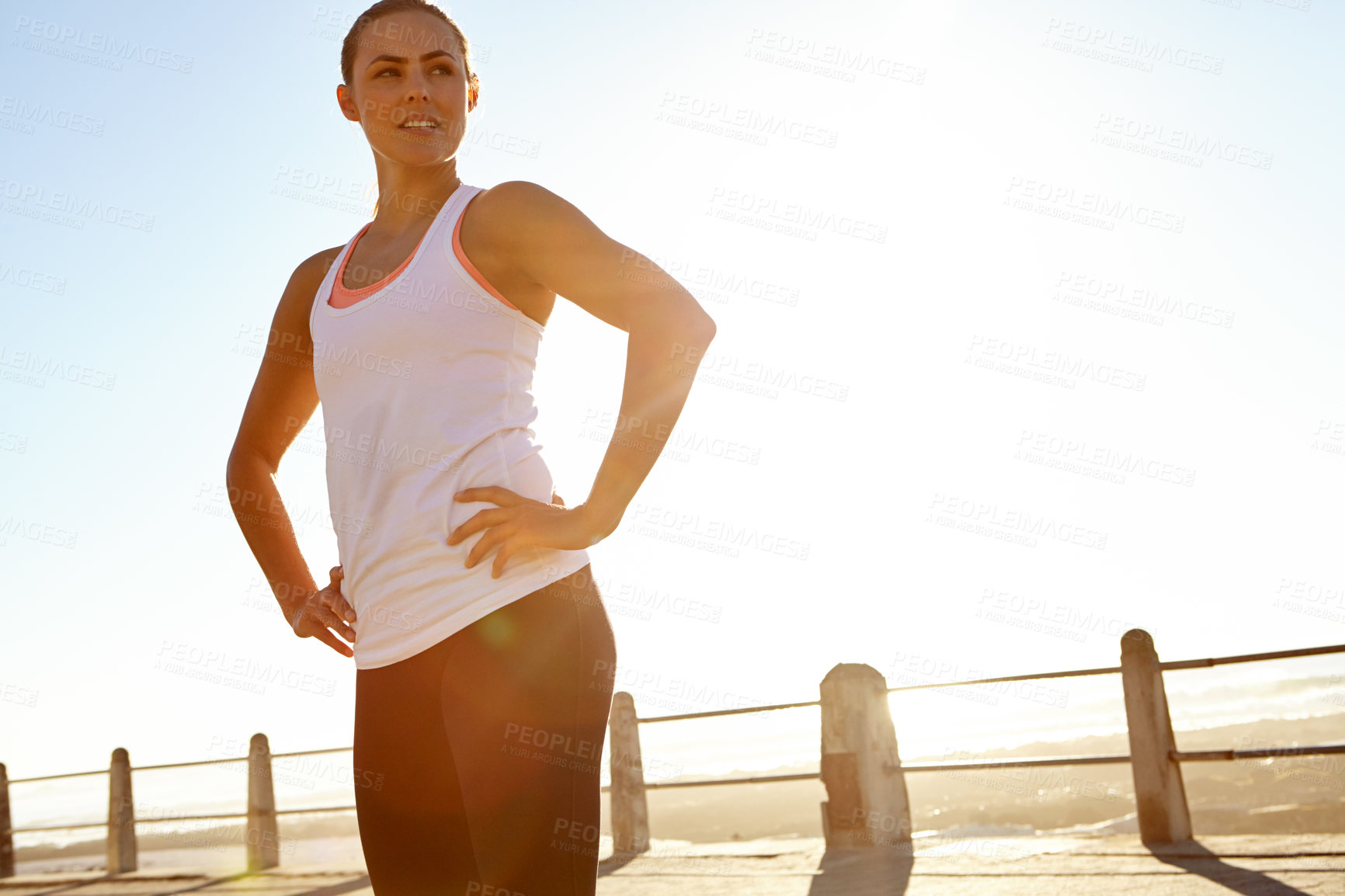 Buy stock photo Shot of a woman in sportswear standing with her hands on her hips