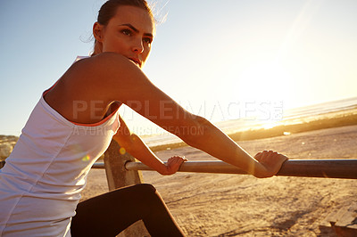 Buy stock photo Shot of a beautiful woman taking a break after her jog