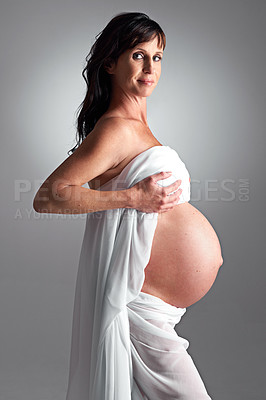 Buy stock photo A pregnant woman holding her tummy