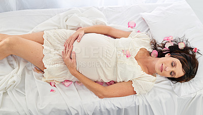 Buy stock photo A pregnant woman holding her tummy