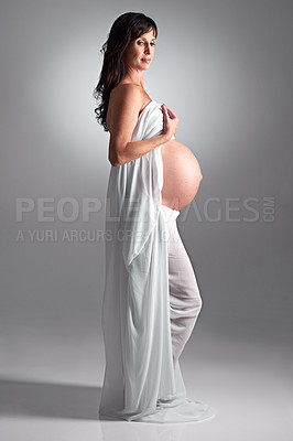 Buy stock photo A pregnant woman holding her tummy