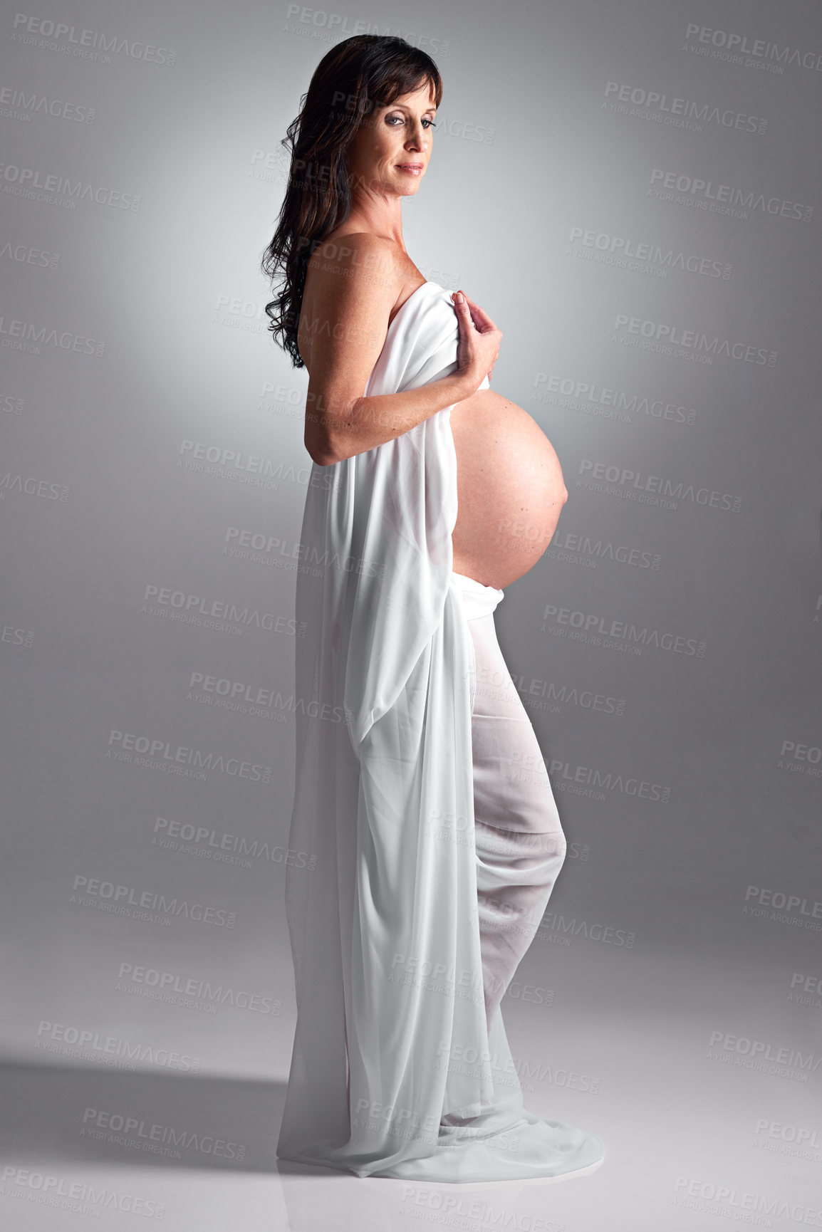 Buy stock photo A pregnant woman holding her tummy