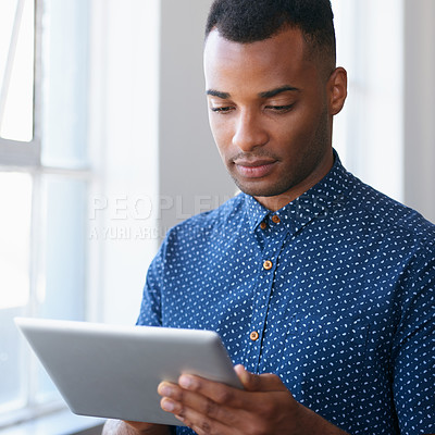 Buy stock photo Businessman, tablet and online at window for communication, internet search and networking in office. Entrepreneur, african employee or serious with technology for corporate email or planning at work