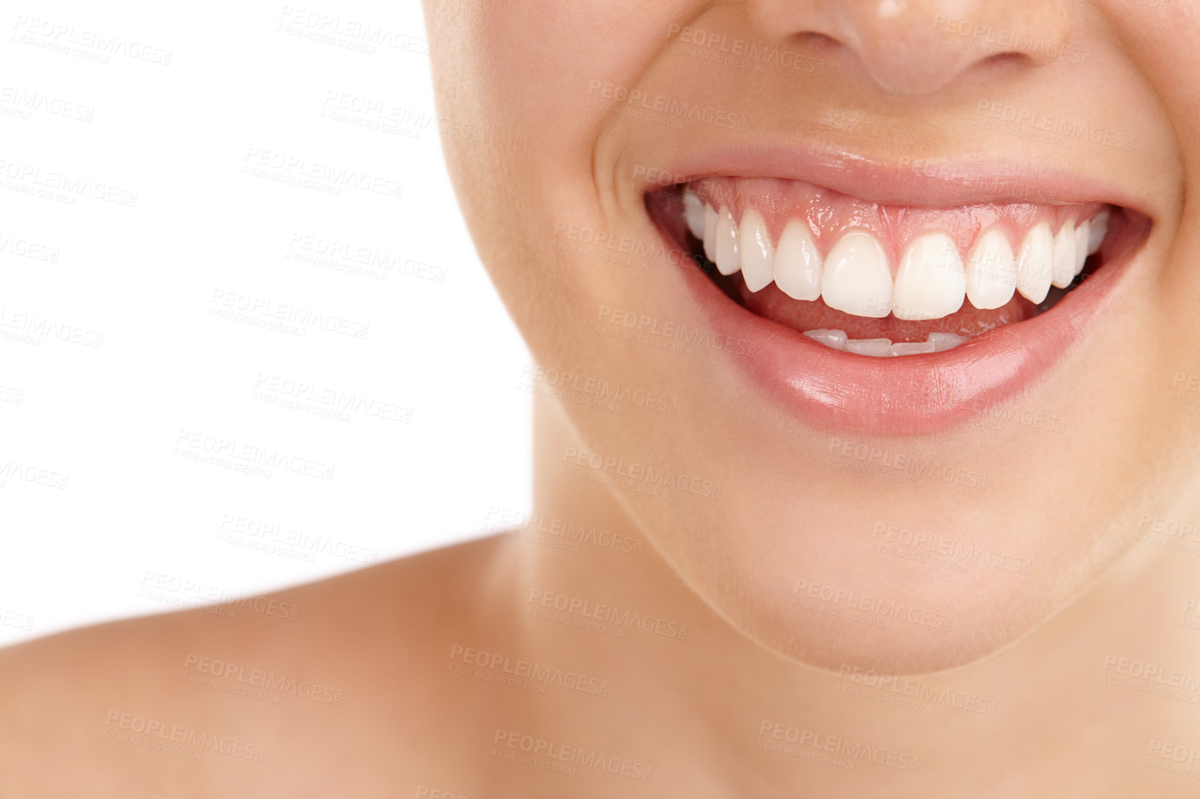 Buy stock photo Closeup shot of a young woman's toothy smile against a white background