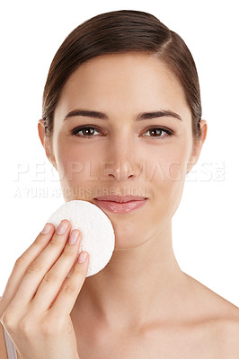 Buy stock photo Cropped portrait of a beautiful young woman exfoliating her face against a white background
