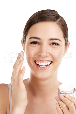 Buy stock photo Cropped portrait of a beautiful young woman applying moisturizer against a white background