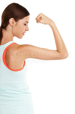 Buy stock photo Shot of a beautiful young woman flexing her muscles