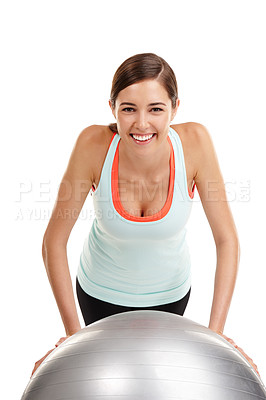 Buy stock photo Shot of a fit  young woman exercising with her exercise ball isolated on white