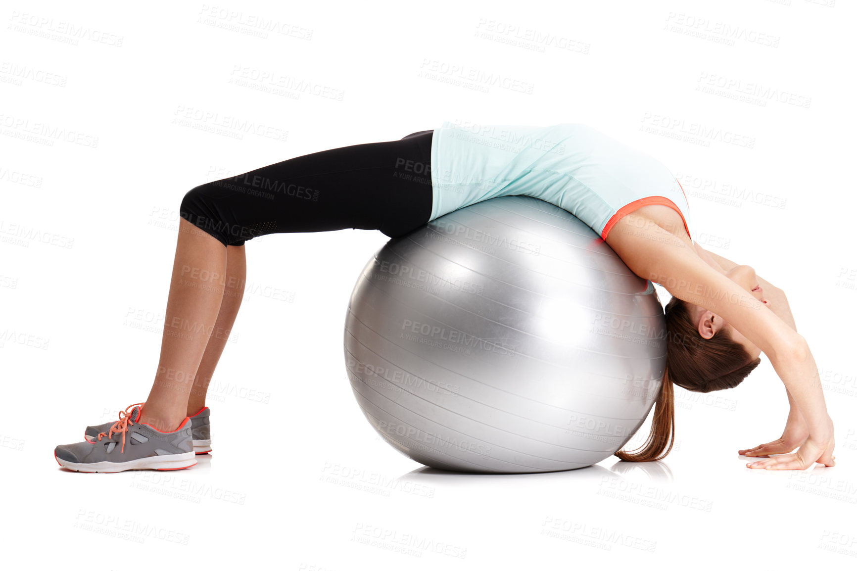 Buy stock photo Shot of a fit  young woman exercising with her exercise ball isolated on white