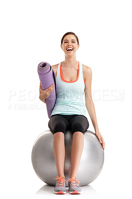 Buy stock photo Shot of a young woman holding a yoga mat while sitting on a exercise ball