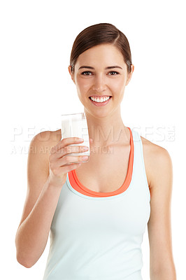 Buy stock photo Cropped shot of a beautiful young woman with a glass of milk in her hand
