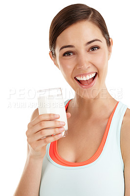 Buy stock photo Cropped shot of a beautiful young woman with a glass of milk in her hand