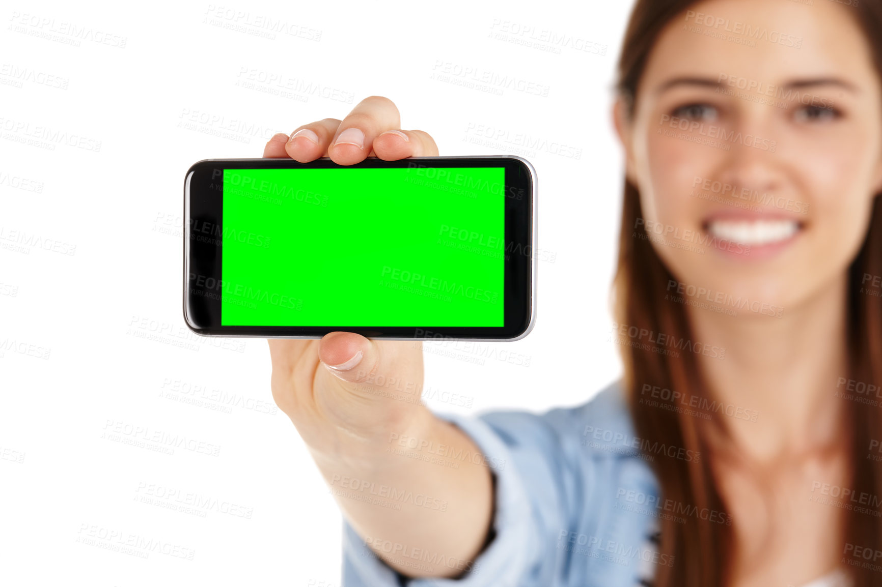 Buy stock photo A young woman holding a mobile phone with green screen copyspace