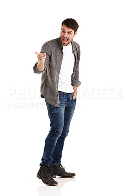 Buy stock photo Full length studio shot of a smiling young man pointing to something surprising