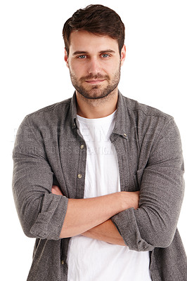 Buy stock photo Studio portrait of a serious young man standing with his arms folded