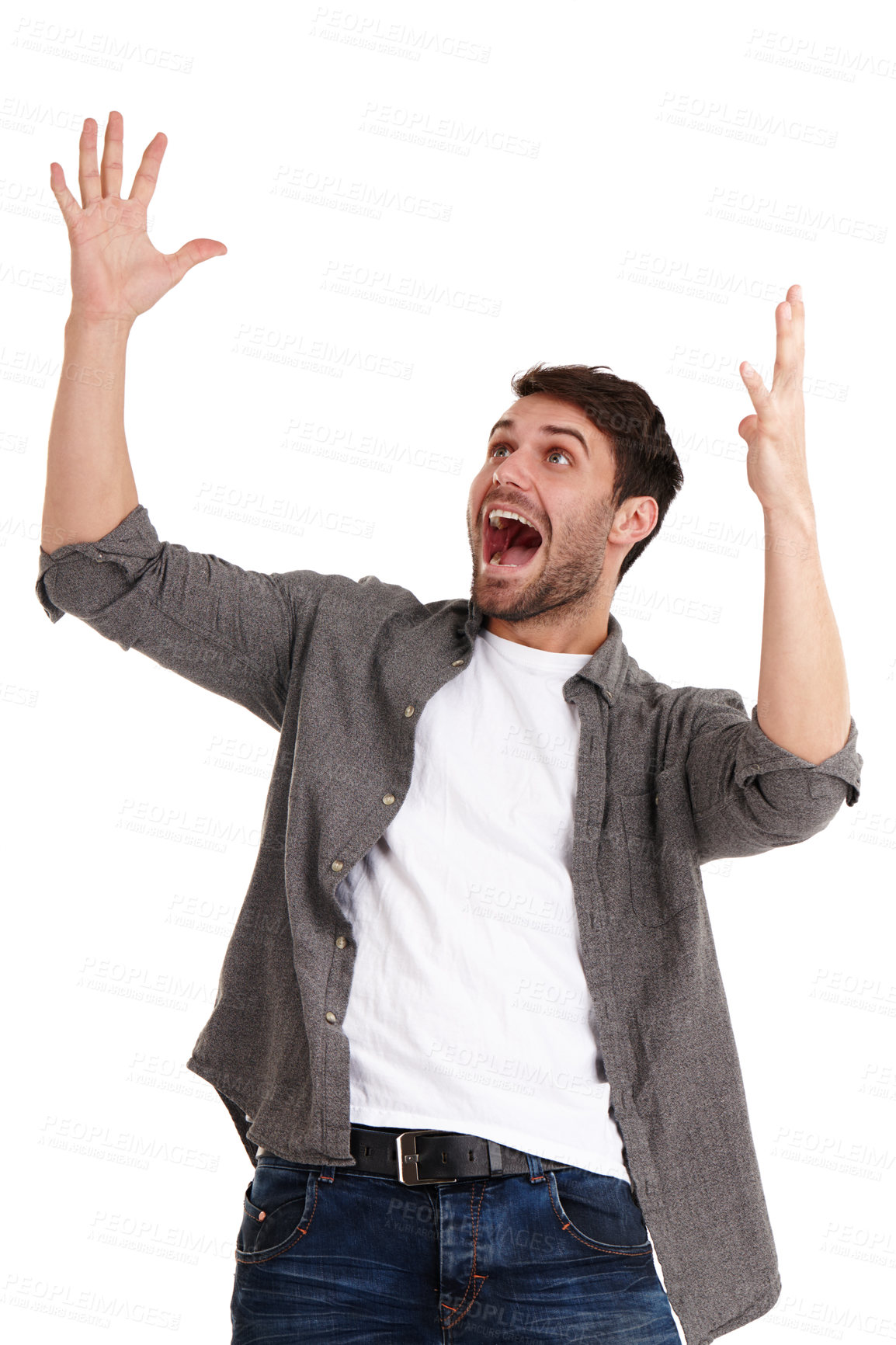 Buy stock photo Studio shot of a smiling young man acting wildly surprised while looking at copyspace