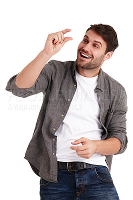 Buy stock photo Studio shot of a young man using his thumb and finger to describe how small something is