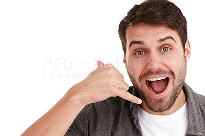 Buy stock photo Studio portrait of a happy young man using a hand gesture to suggest you call him