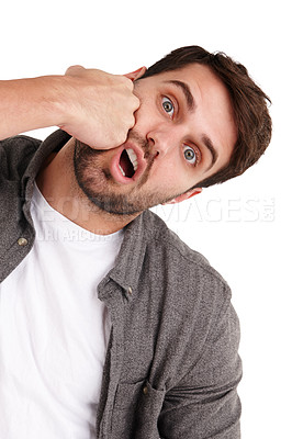 Buy stock photo Studio portrait of a young man punching himself in the face