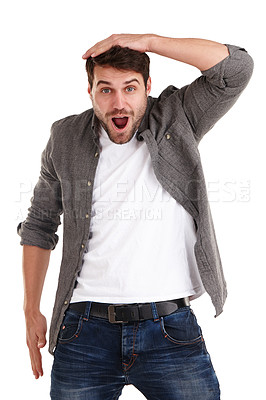 Buy stock photo Studio shot of a young man holding his head and looking with amazement at the camera