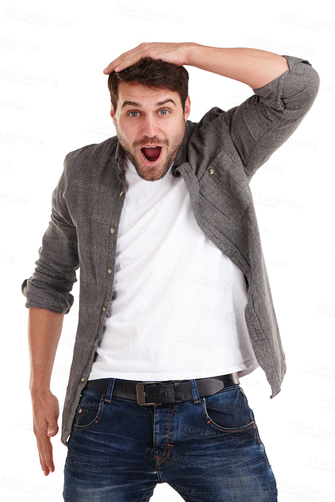 Buy stock photo Studio shot of a young man holding his head and looking with amazement at the camera