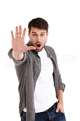 Buy stock photo Studio portrait of a young man holding up his hand telling you to stop