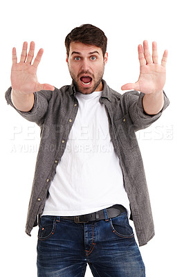 Buy stock photo Studio portrait of a young man holding up his hands telling you to stop