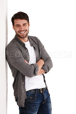 Buy stock photo Studio shot of a happy young man standing with his arms folded