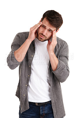 Buy stock photo Studio shot of a young man grimacing in pain while rubbing his forehead