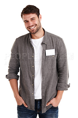 Buy stock photo Studio portrait of a smiling young man with a blank nametag standing with his hands in his pockets