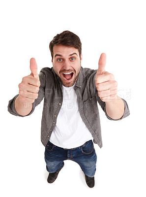 Buy stock photo High-angle shot of a happy young man in studio showing two thumbs up
