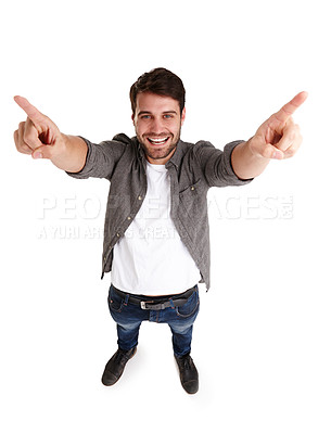 Buy stock photo High-angle portrait of a happy young man in studio raising his arms and pointing