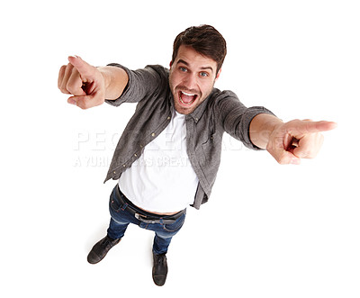 Buy stock photo High-angle portrait of an excited young man in studio raising his arms and pointing