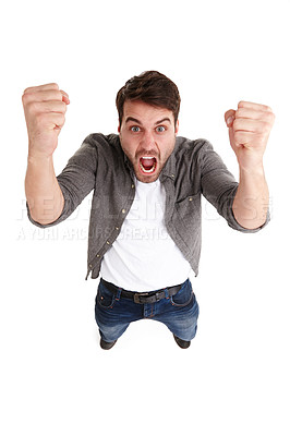 Buy stock photo High-angle shot of an angry young man in studio shaking his fists with fury