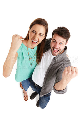 Buy stock photo High-angle shot of a happy young couple in studio raising their fists in victory