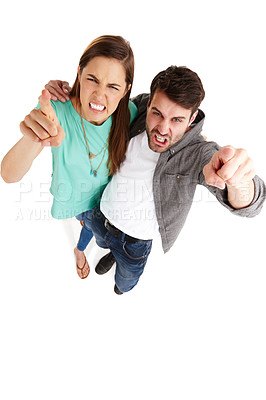 Buy stock photo High-angle shot of a young couple in a studio pointing their fingers at you angrily