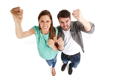 Buy stock photo High-angle shot of a young couple in a studio shaking their fists angrily at the camera