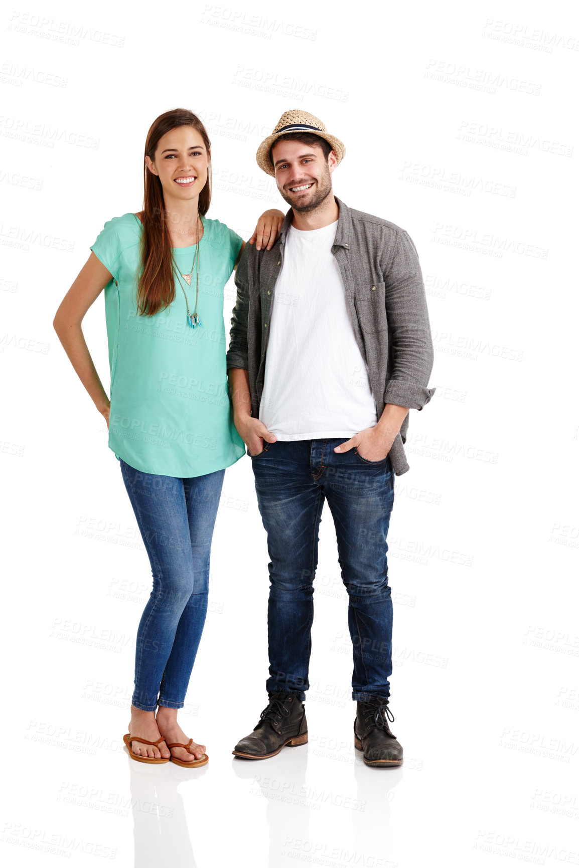 Buy stock photo Studio shot of a smiling young couple in casual clothes standing alongside each other
