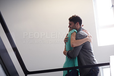 Buy stock photo Shot of two people hugging in a stairwell