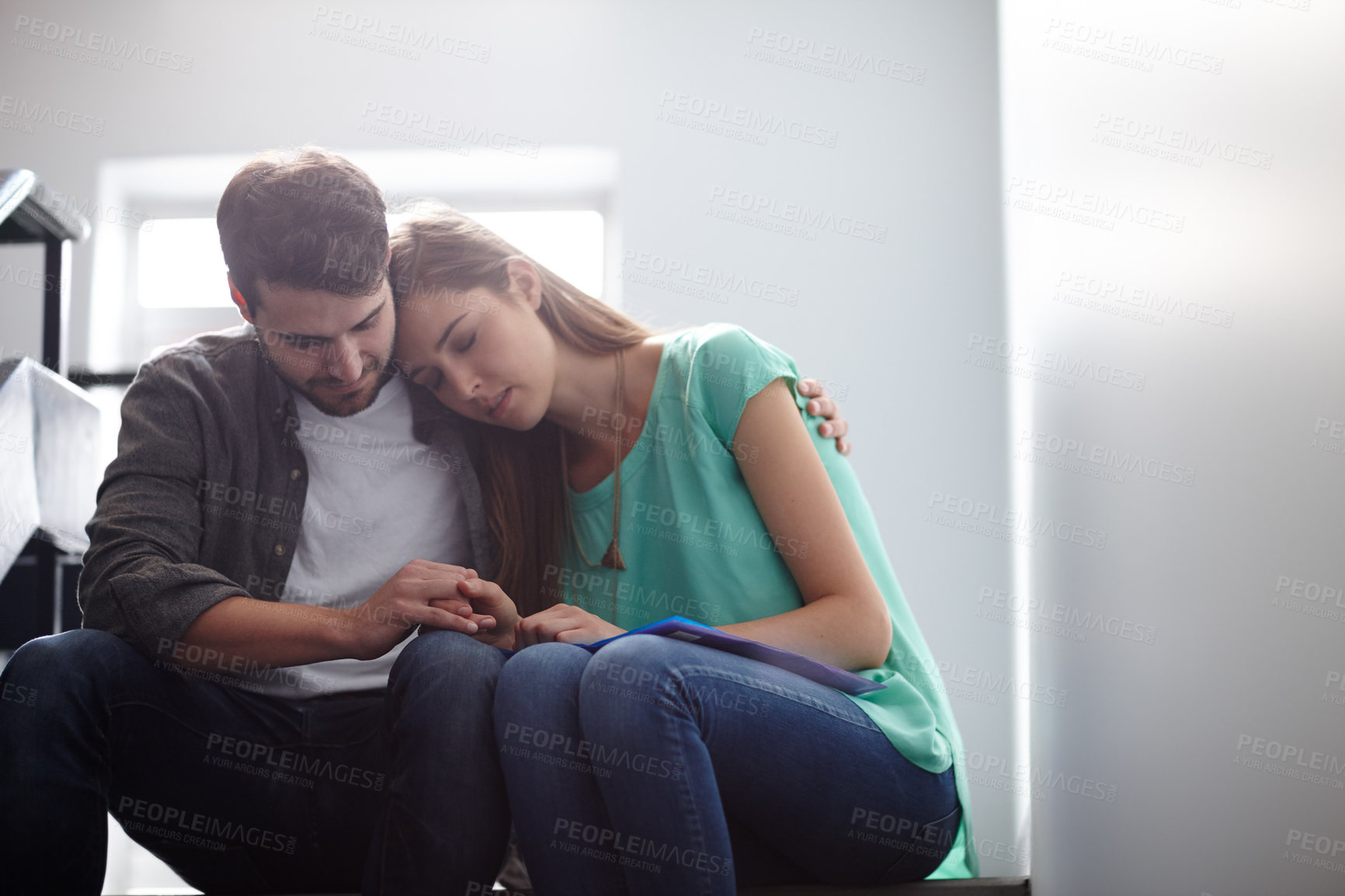 Buy stock photo Shot of a man comforting a distressed woman in a stairwell