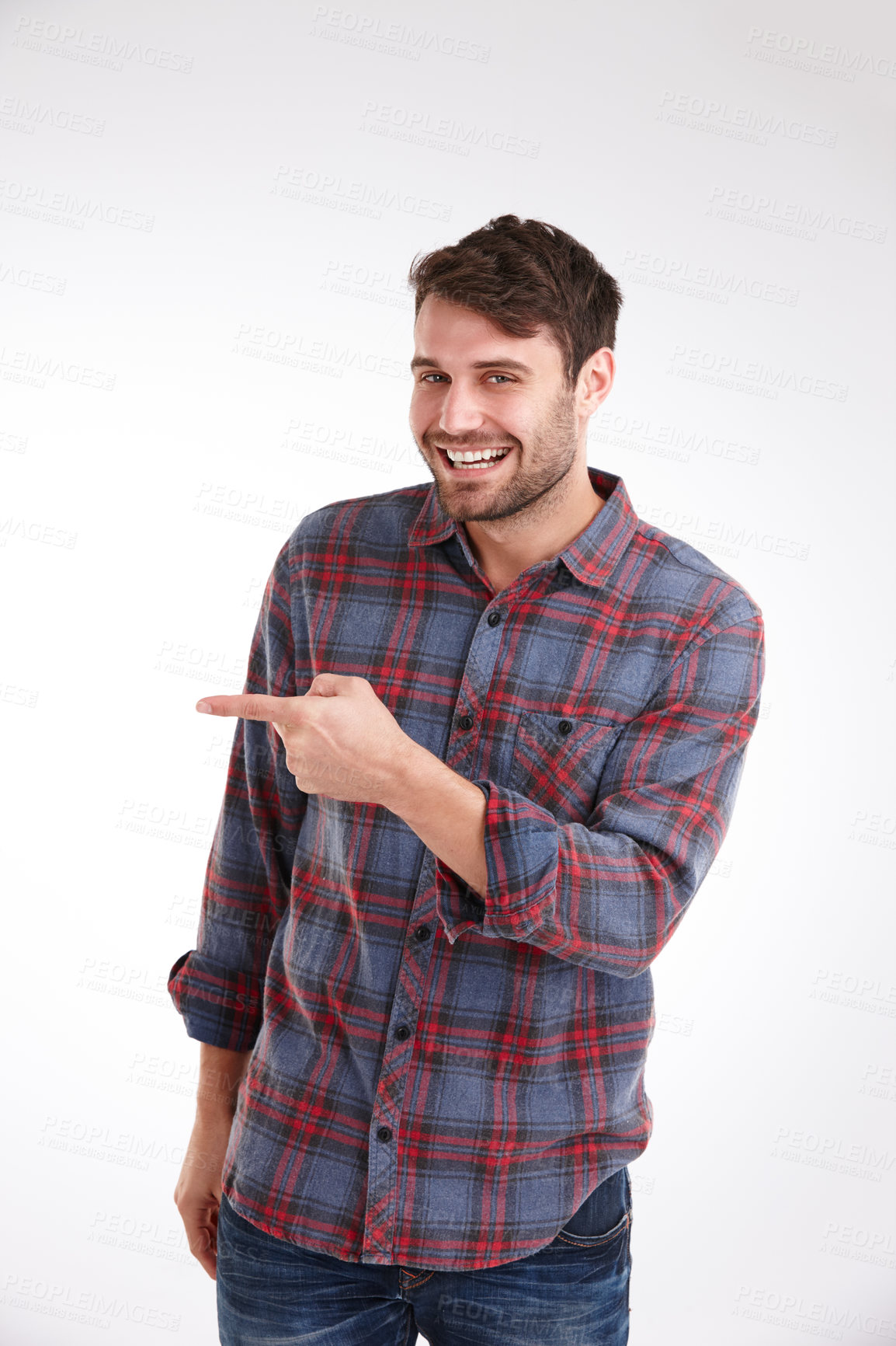 Buy stock photo Studio portrait of a smiling young man pointing at copyspace to the left